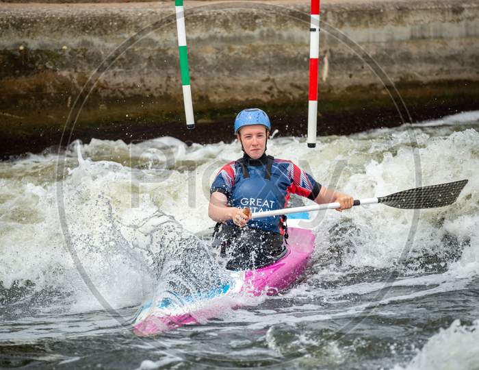 Gb Canoe Slalom Athlete Crossing White Water After Negotiating An Upstream Gate On A Wave. Women'S C1W Class