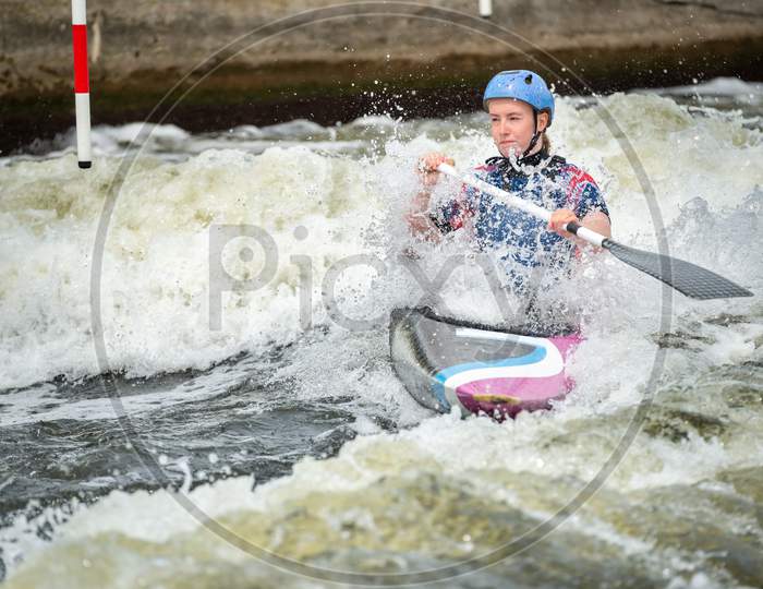 Gb Canoe Slalom Athlete With White Water Splashing Around Her As She Crosses A Wave. Women'S C1W Class