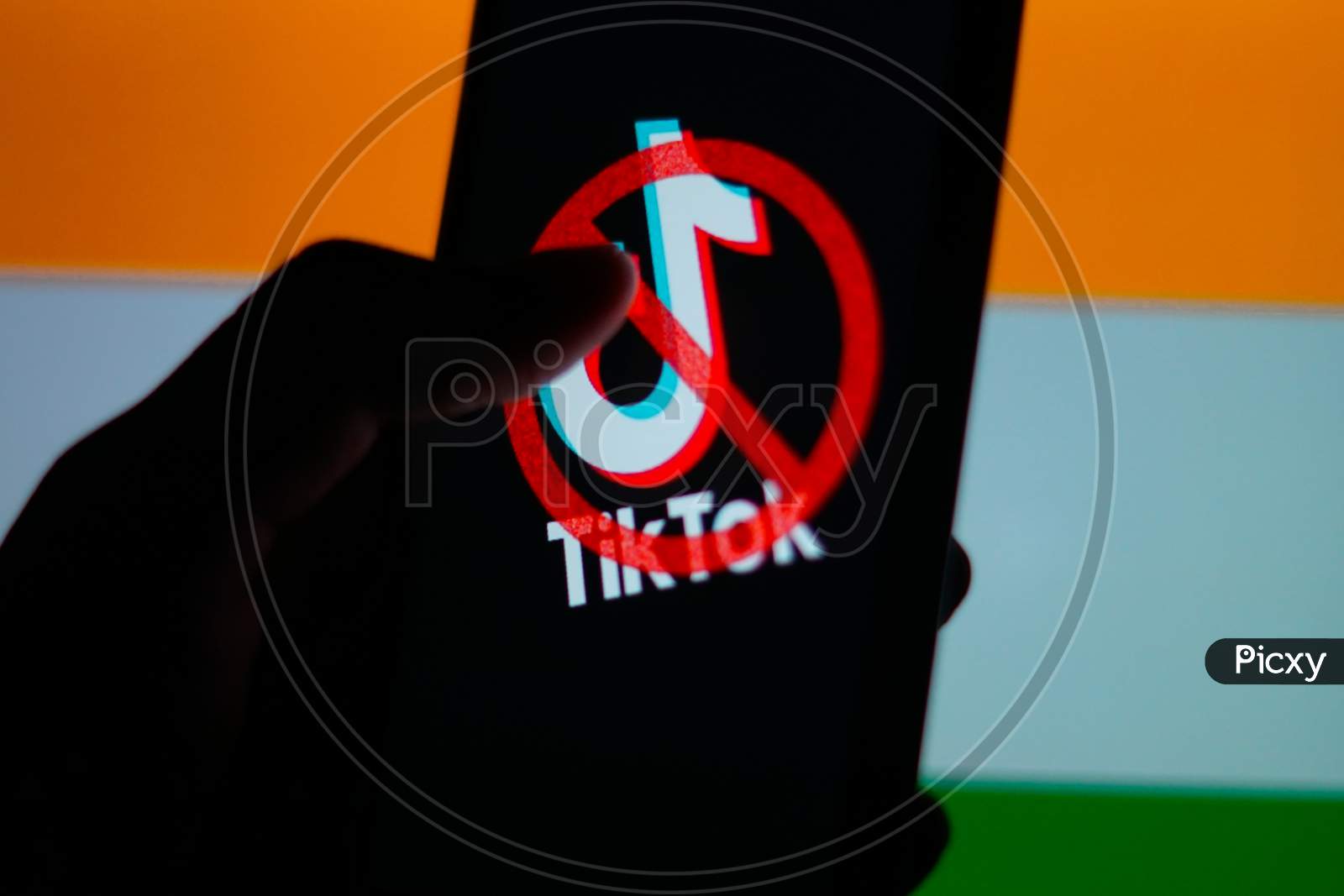 Tiktok Application Logo On A Mobile Screen and a finger about to touch with Indian Flag in the background