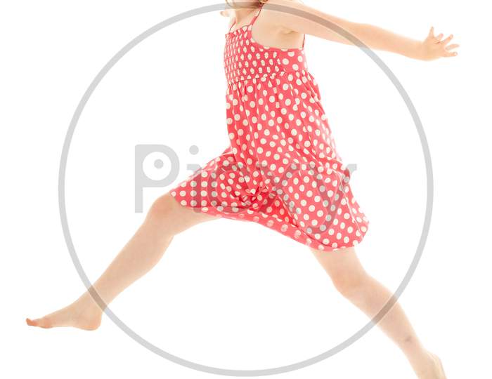 Beautiful Young Blonde Girl Jumping Across The Frame Wearing Pink And White Polka Dot Dress And Classy White Framed Sunglasses. Isolated On White Studio Background