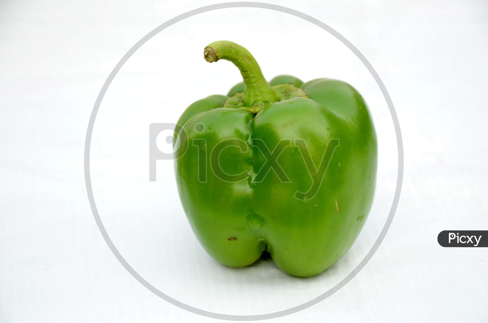ripe green capsicum isolated on white background.