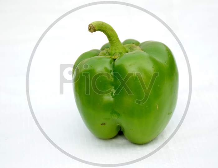 ripe green capsicum isolated on white background.