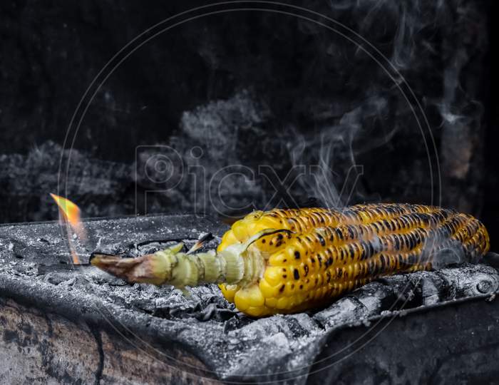 Roasted Sweet Corn On Charcoal At A Roadside Stall During Monsoon In India.