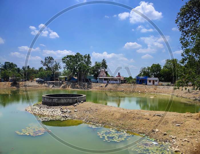 Village Water Well Located On Pond.The Large Diameter Water Well On The Center Of The Temple Pond In Indian Village.