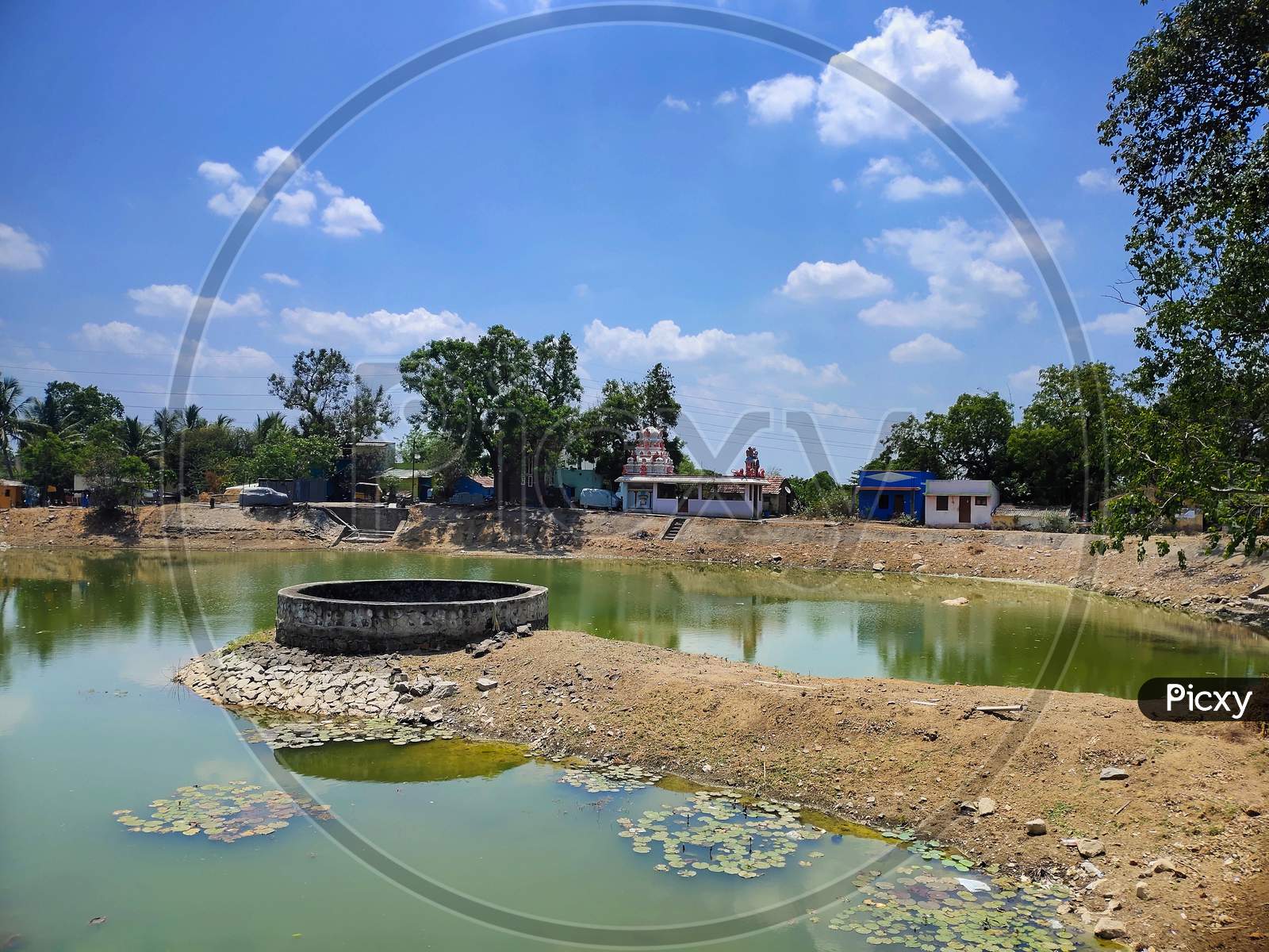 Village Water Well Located On Pond.The Large Diameter Water Well On The Center Of The Temple Pond In Indian Village.
