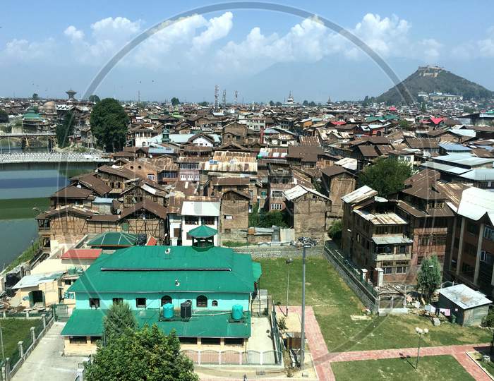 A Green Buildings Hill And A View Of Old Srinagar