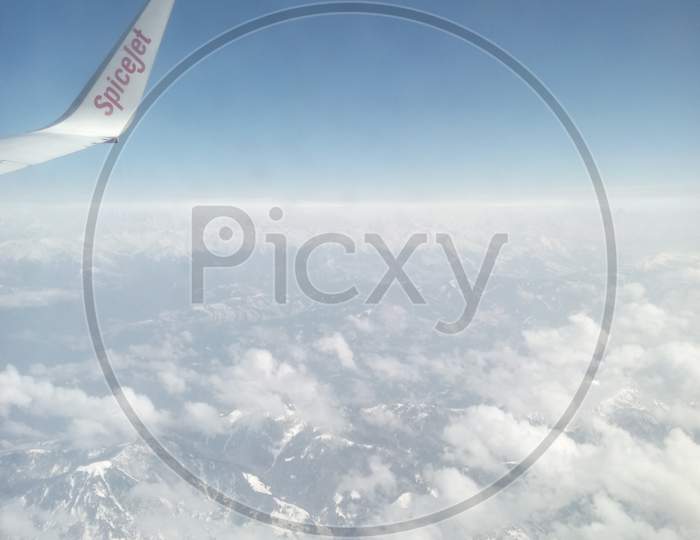 Spice Jet Flying On Snowy Clouds