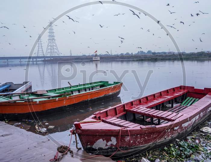 Colorful Boats Being Parked At The Bank Of Yamuna River Near Nigam Bodh Ghat.