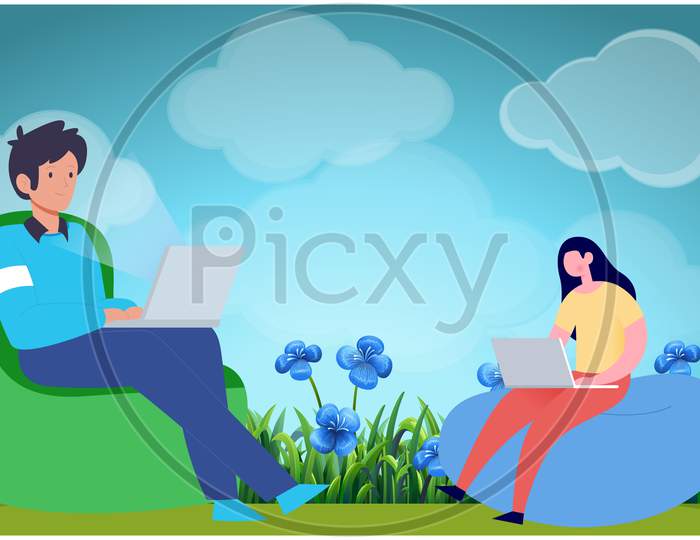 Boy And Girl Sitting In A Garden Working On Laptop
