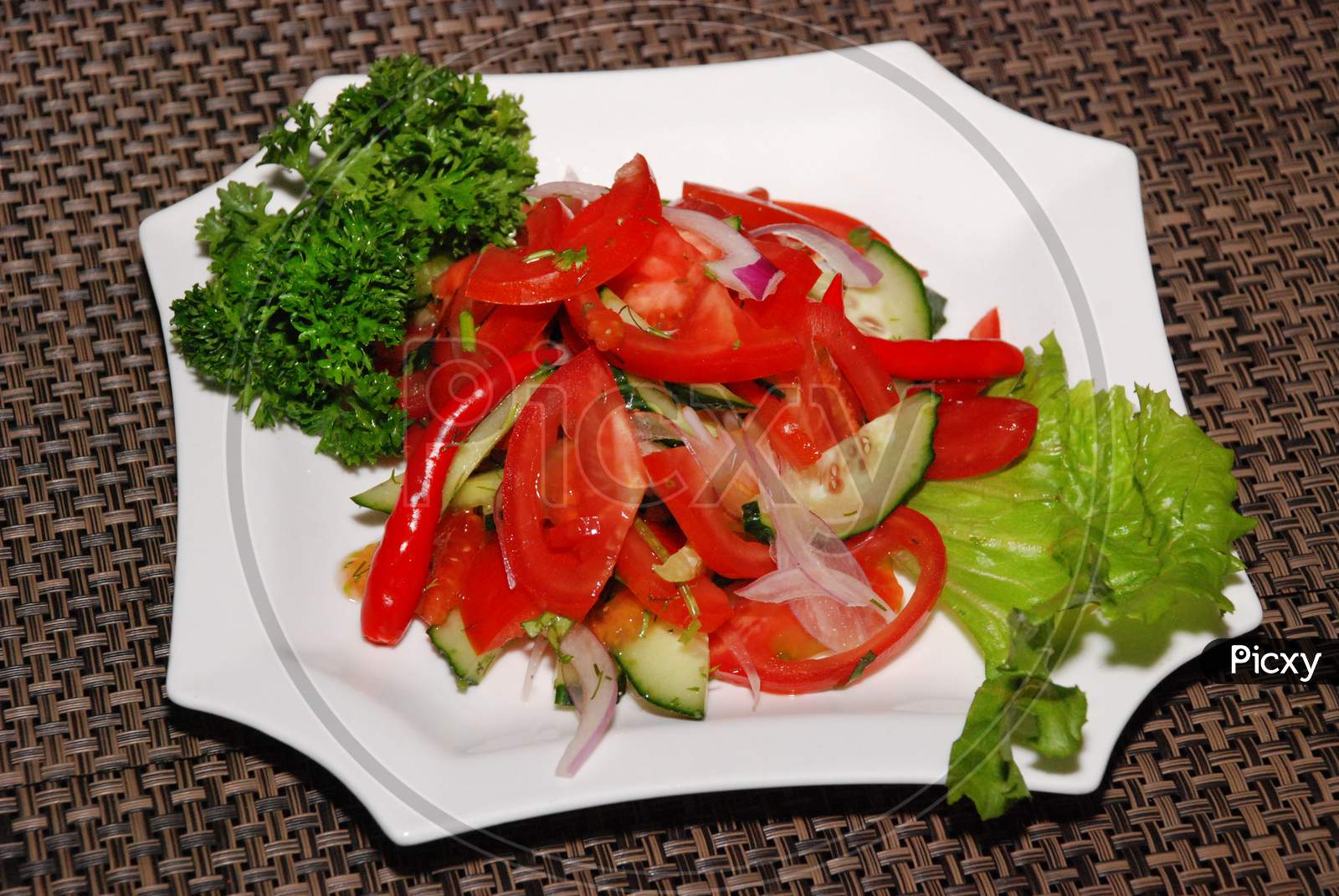 Vegetable Salad With Tomatoes On The White Plate