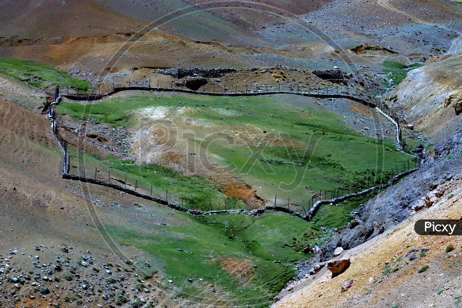 A landscape in visible features of an area of land, landforms, integrate with natural man-made features.Kargil Ladakh is famous for travelling, mountains, hills, villages beauty greenery and wast land and water bodies