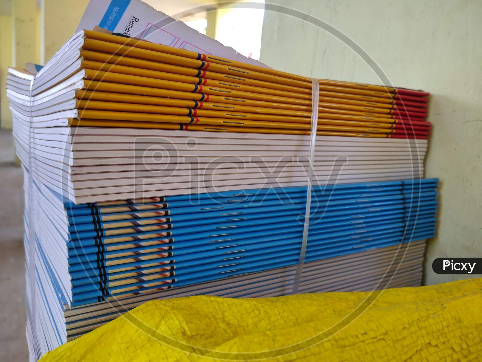 Bundle Of Multicolored Exercise Books Are Ready To Distribute To School Students. Bunch Of School Edge Book.