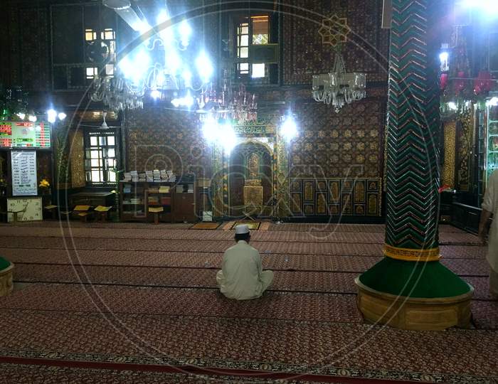 Masjid And A Man Prays In Old Downtown Area