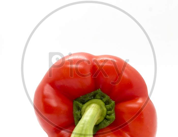 Close up of a fresh organic red bell pepper with white background.
