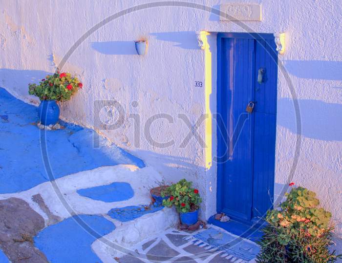 Blue Painted Door On Narrow Street In Plaka, Milos
