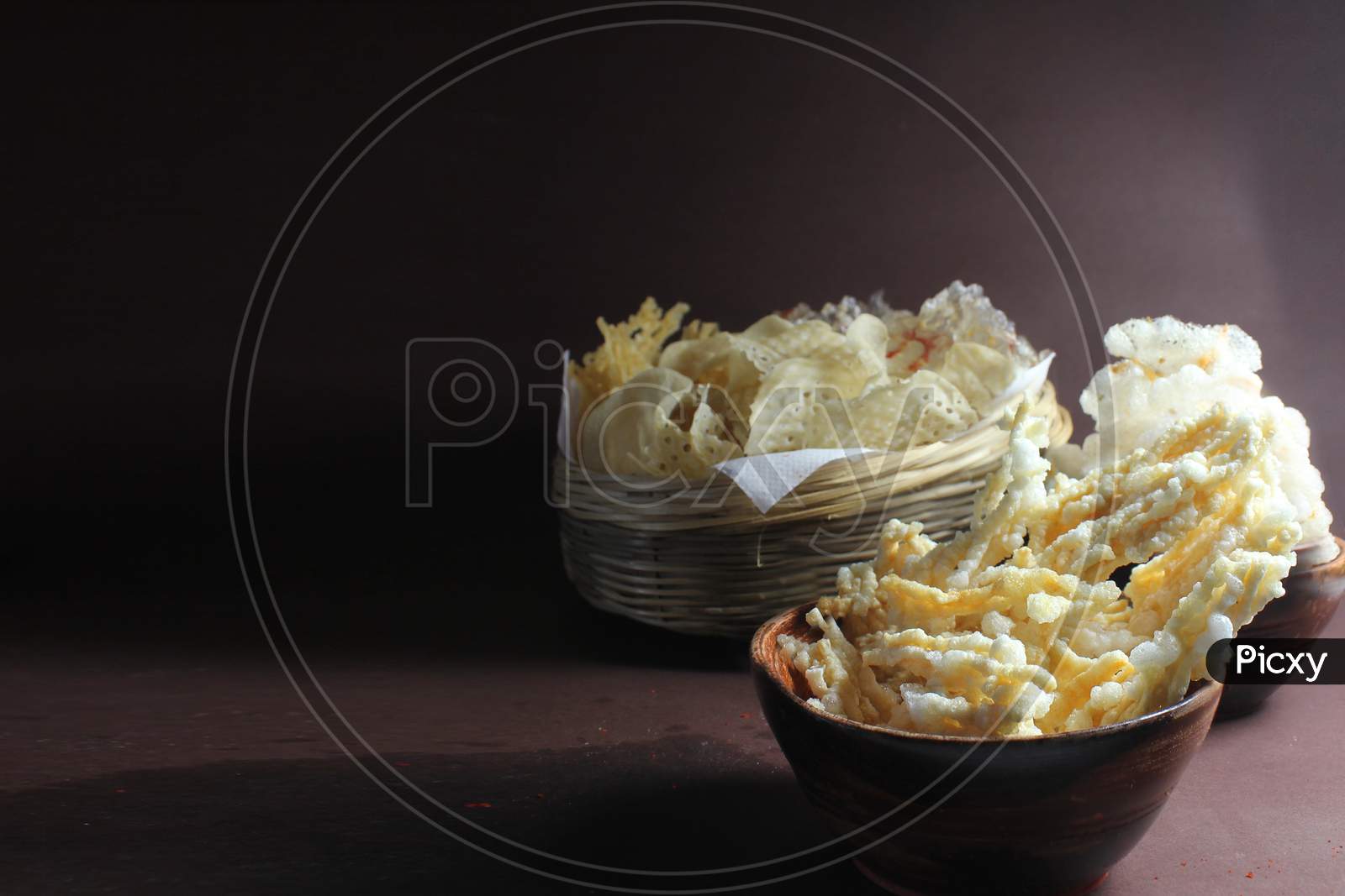Homemade deep fried potato chips and sago wafers.