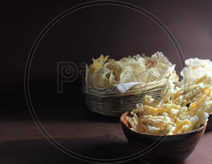 Homemade deep fried potato chips and sago wafers.