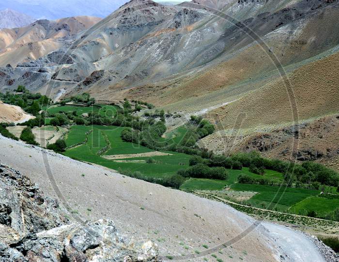 A landscape in visible features of an area of land, landforms, integrate with natural man-made features.Kargil Ladakh is famous for travelling, mountains, hills, villages beauty greenery and wast land and water bodies