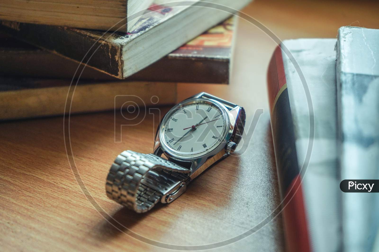 Old Vintage Watch And Some Books On A Table