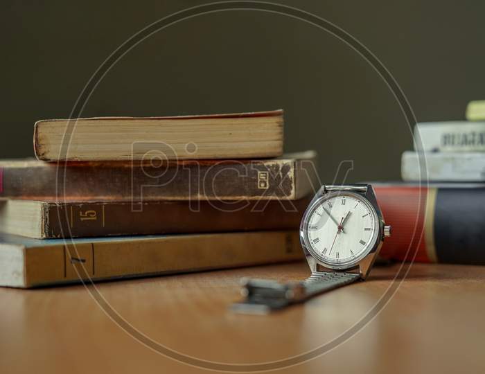 Old Vintage Watch And Some Books On A Table