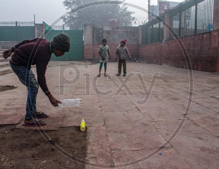 New Delhi, Delhi/ India- May 31 2020:New Delhi, Delhi/ India- May 31 2020: Three Small Kids Playing In Early Morning With Bottles.