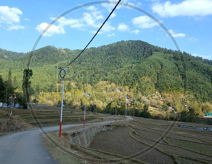 A Beautiful View Of A Village A Road Electric Pools Wire And Forests