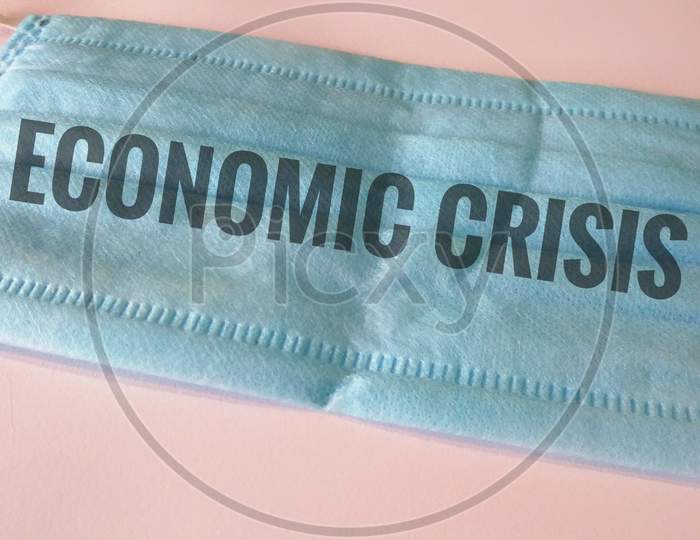 Economic crisis written on medical face mask