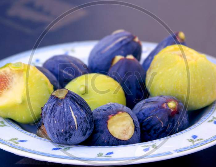 Violet And Green Figs On White Plate, A Fruit Meal
