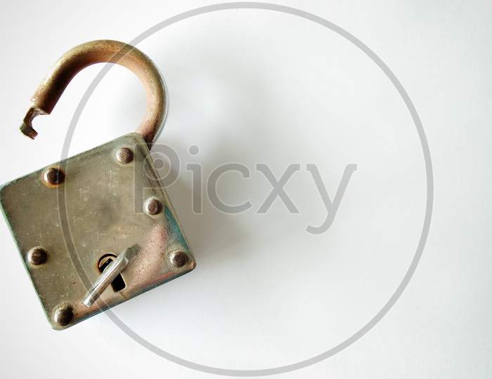 Old vintage lock with key on white background, copy space for text