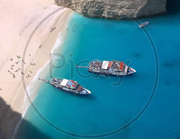 Tourists arriving on Shipwreck Beach on the Island of Zakynthos Greece.