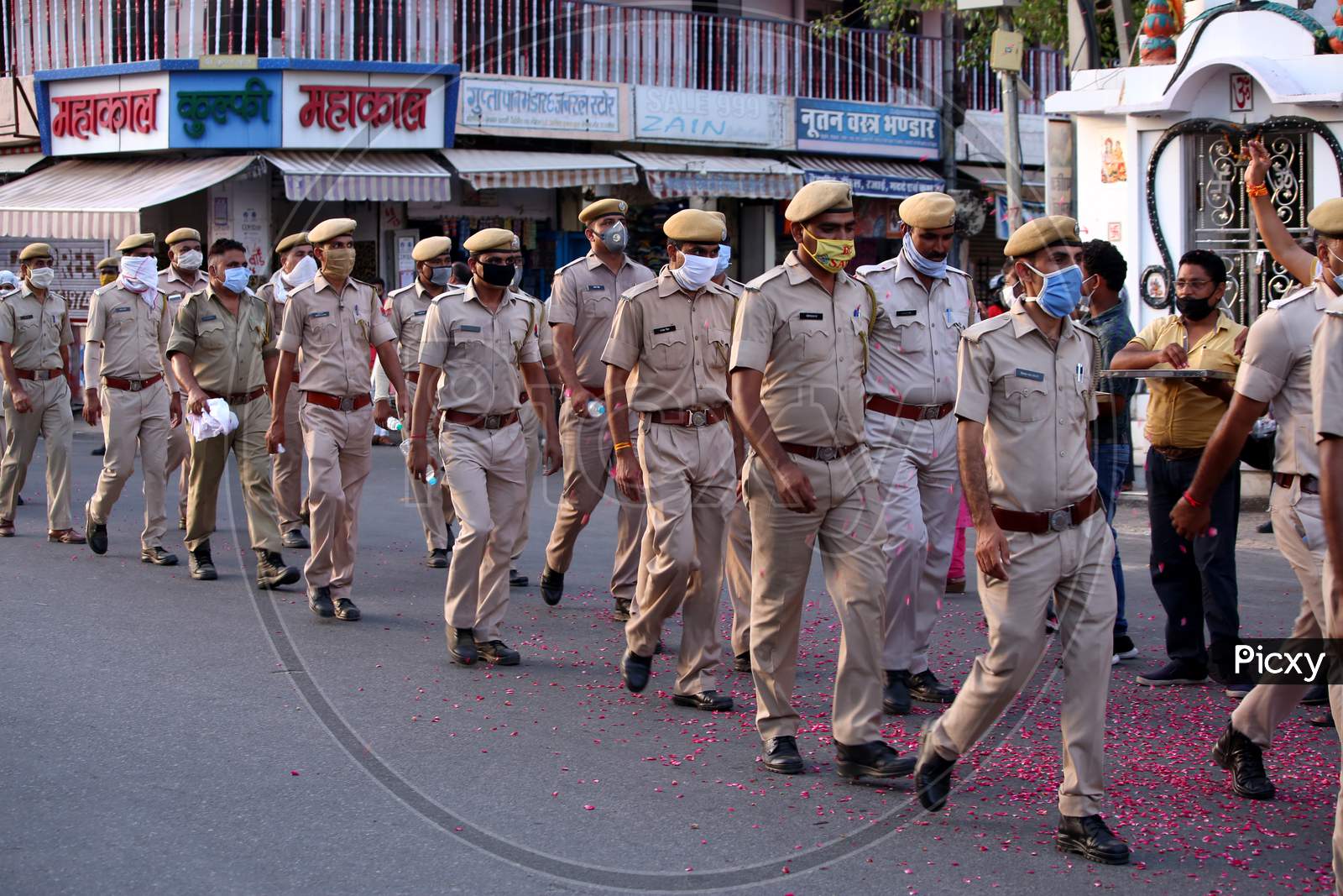 Police officers participate in a flag march organised to spread awareness on Covid-19 during a lockdown in Ajmer, Rajasthan