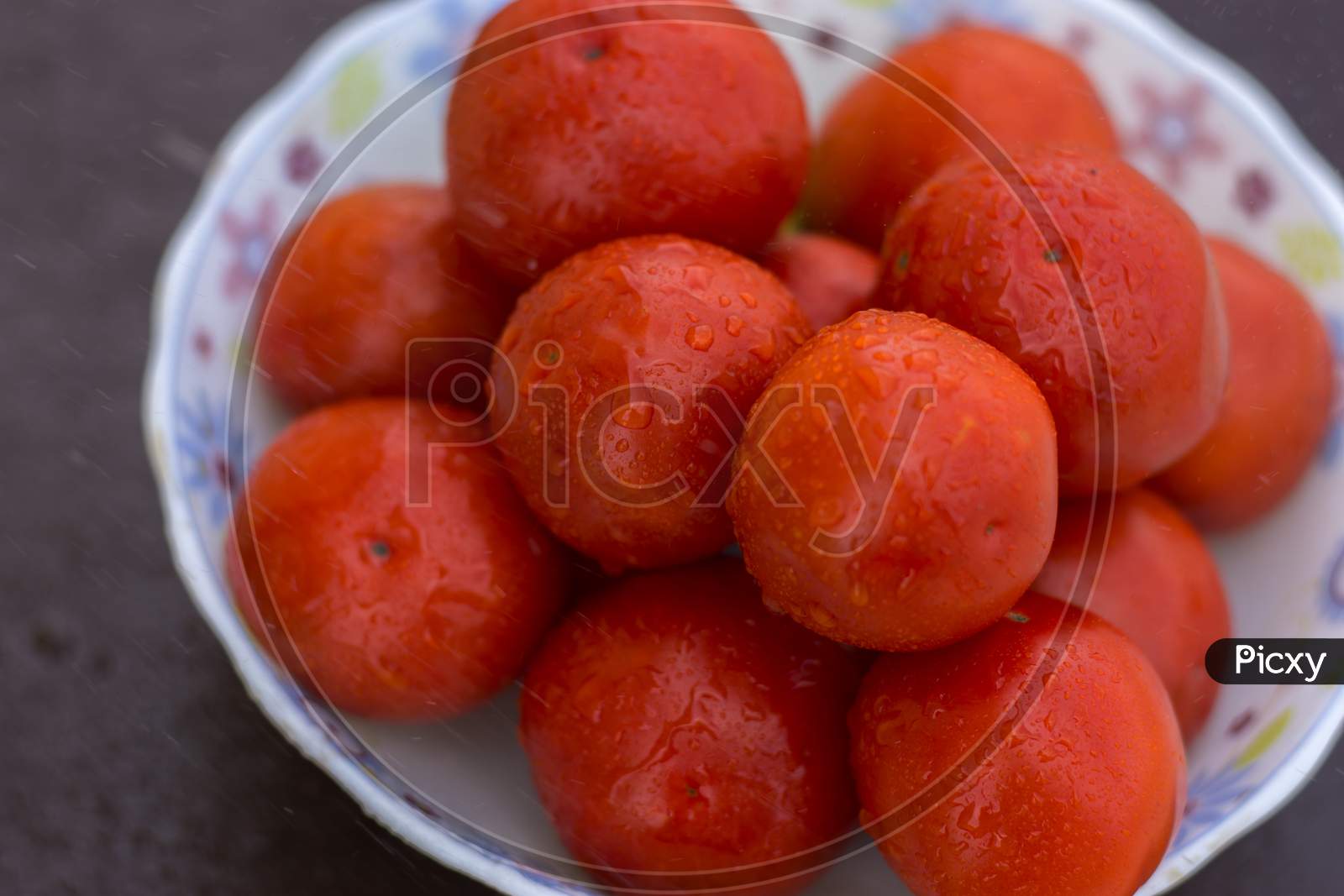Red Organic Tomatoes In A Bowl