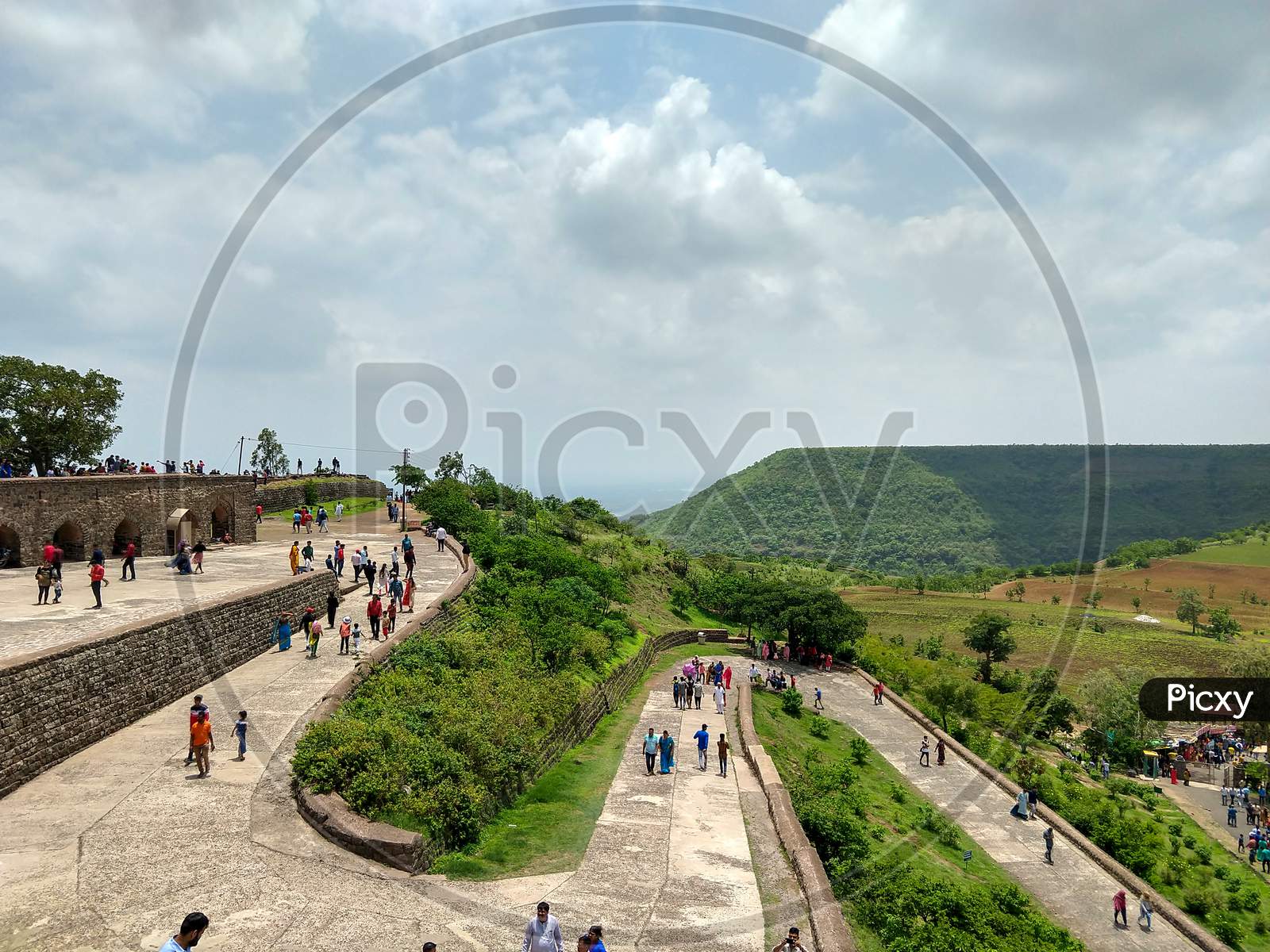 Mandav, Madhya Pradesh, India- July 14, 2019: Spiral Concrete Road to Enter In Rani Rupmati Mahal/Pavilion At Mandu. People Are Coming To Visit This Heritage Place. A Flat Top Hill In The Background.