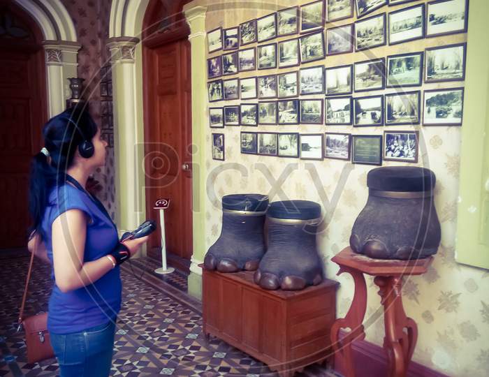 Tourist observing the photos hung on the wall in Bangalore palace, Jayamahal palace in Bangalore Karnataka India.