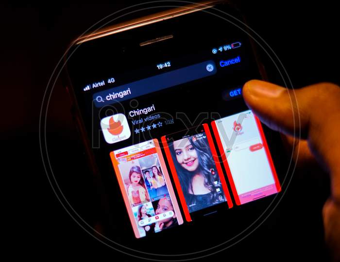 Chingari App logo on Mobile screen with a finger about to download