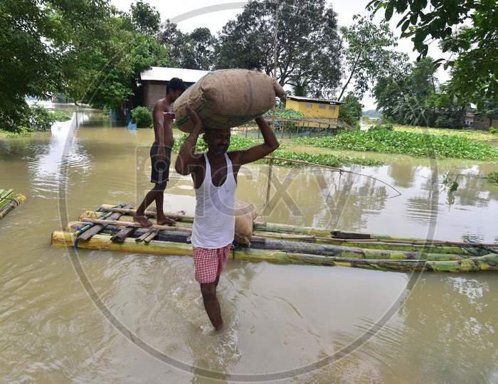 Flood Affected Villagers Transport Sacks Of Rice Towards A Safer Place At  Mayong  In Morigaon District Of Assam On June 29, 2020.