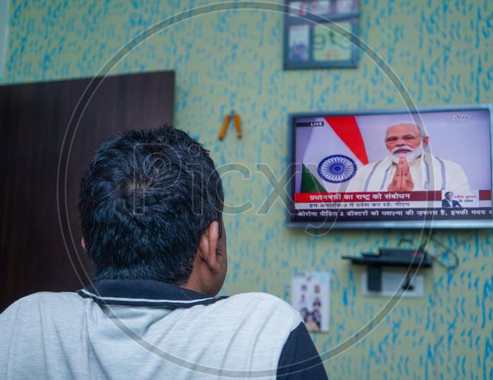 New Delhi, Delhi/ India- June 30 2020: A Man Watching The Live Tv Of Prime Minister Narendra Modi'S Announcement About Unlock India From Corona Virus At A House In New Delhi.