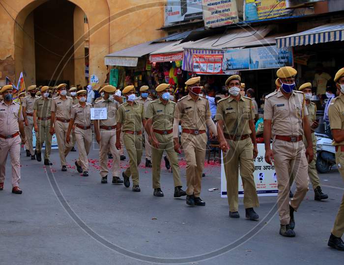 Police officers participate in a flag march organised to spread awareness on Covid-19 during a lockdown in Ajmer, Rajasthan