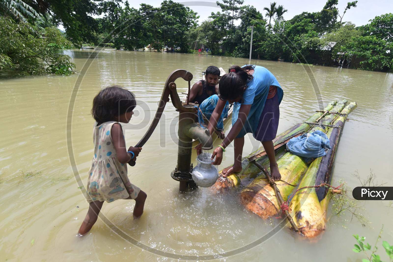 Girls Collect Drinking Water From A Partially submerged  Hand Pump At  Mayong Village In Morigaon District Of Assam On June 29, 2020