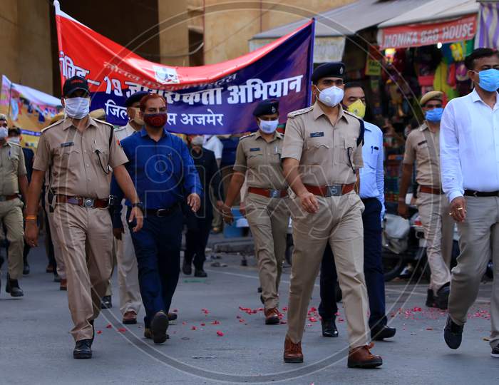 Police personnel and civilians participate in the flag march to spread awareness on Covid-19 in Ajmer, Rajasthan on July 02, 2020