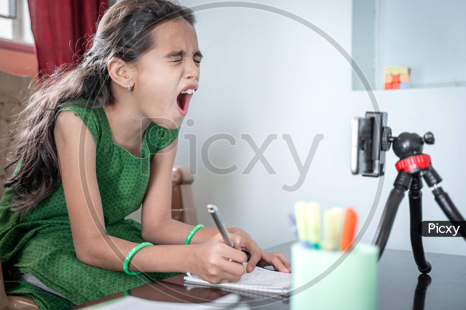 Girl Shouting, Screaming In Front Of Mobilephone During E-Learning Or Online Class At Home - Concept Of Problem, Stress, Anxiety For Students Or Kids In Distance Learning.