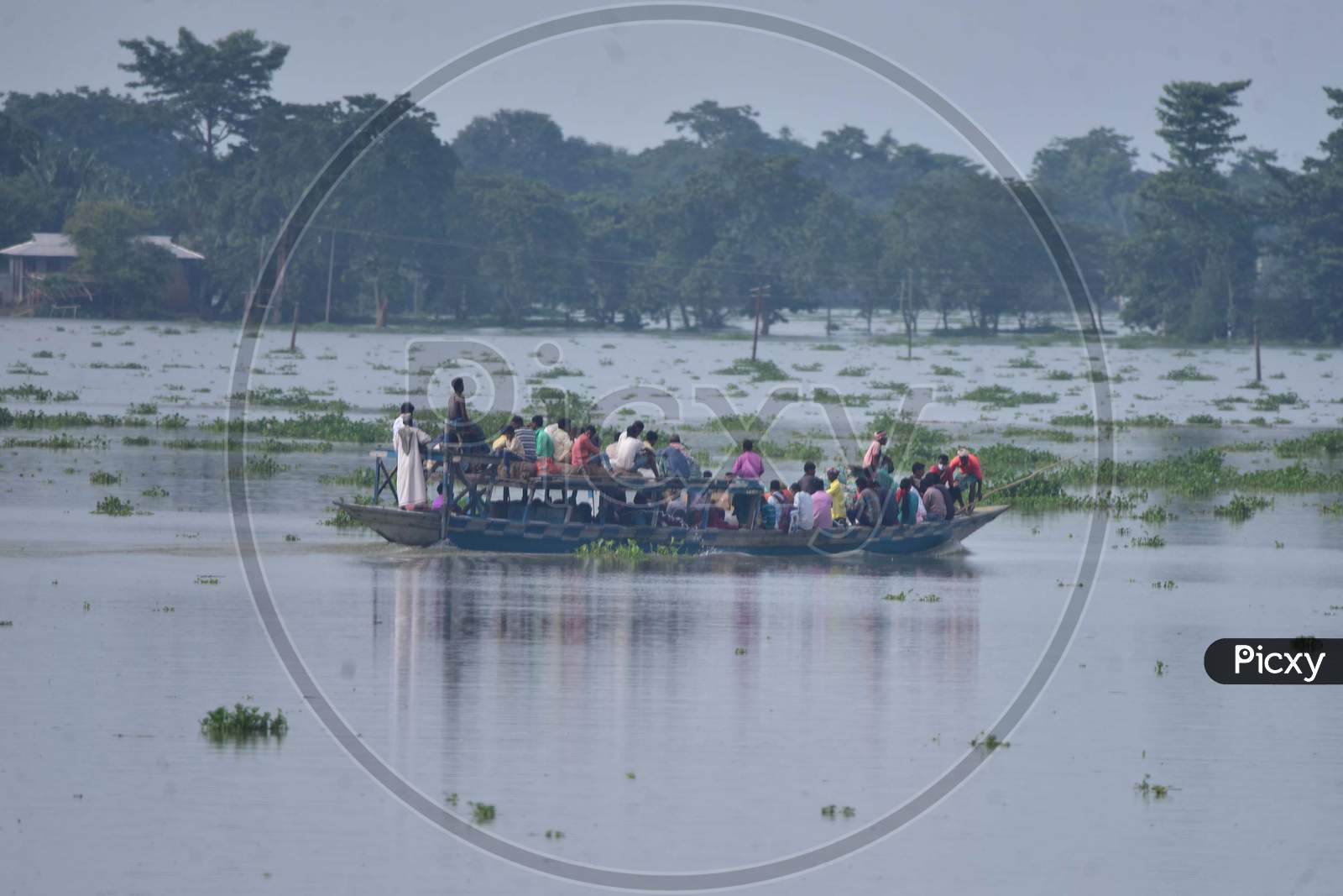 Flood Affected Villagers Are Transported On A Boat  Towards A Safer Place At  Sildubi Village In Morigaon District Of Assam On June 29, 2020