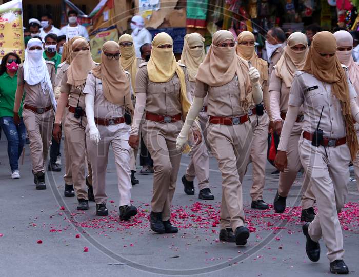 Female police officers cover their faces during a flag march to spread awareness on Covid-19 in Ajmer, Rajasthan on July 02, 2020