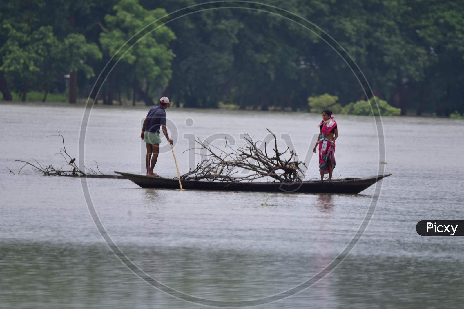 Flood Affected Villagers Travel On A Boat Towards A Safer Place During Floods  At  Sildubi Village In Morigaon District Of Assam On June 29, 2020