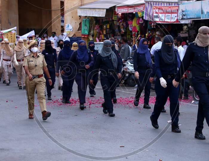 Female Police officers participate in a flag march organised to spread awareness on Covid-19 during a lockdown in Ajmer, Rajasthan