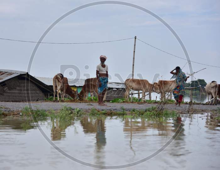 Villagers Take Shelter On A Road As Their Village Is Submerged By Flood Waters In The Flood Affected   Sildubi Village In Morigaon District Of Assam On June 29,2020.