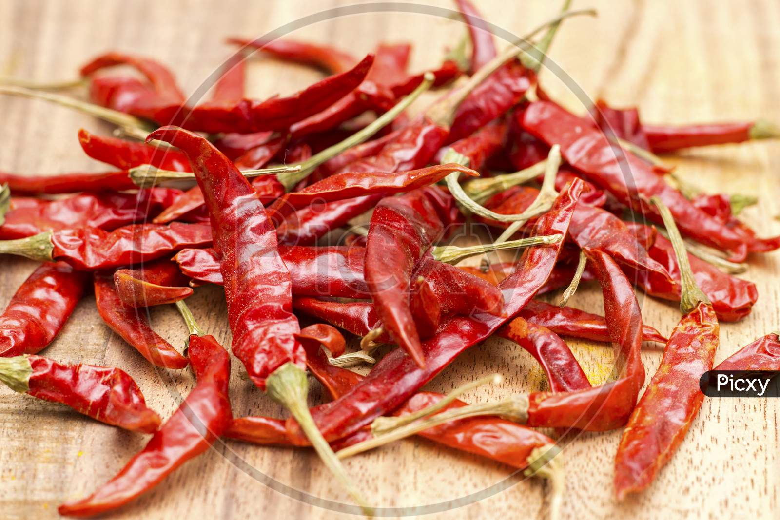 dry red chilli powder with wooden background