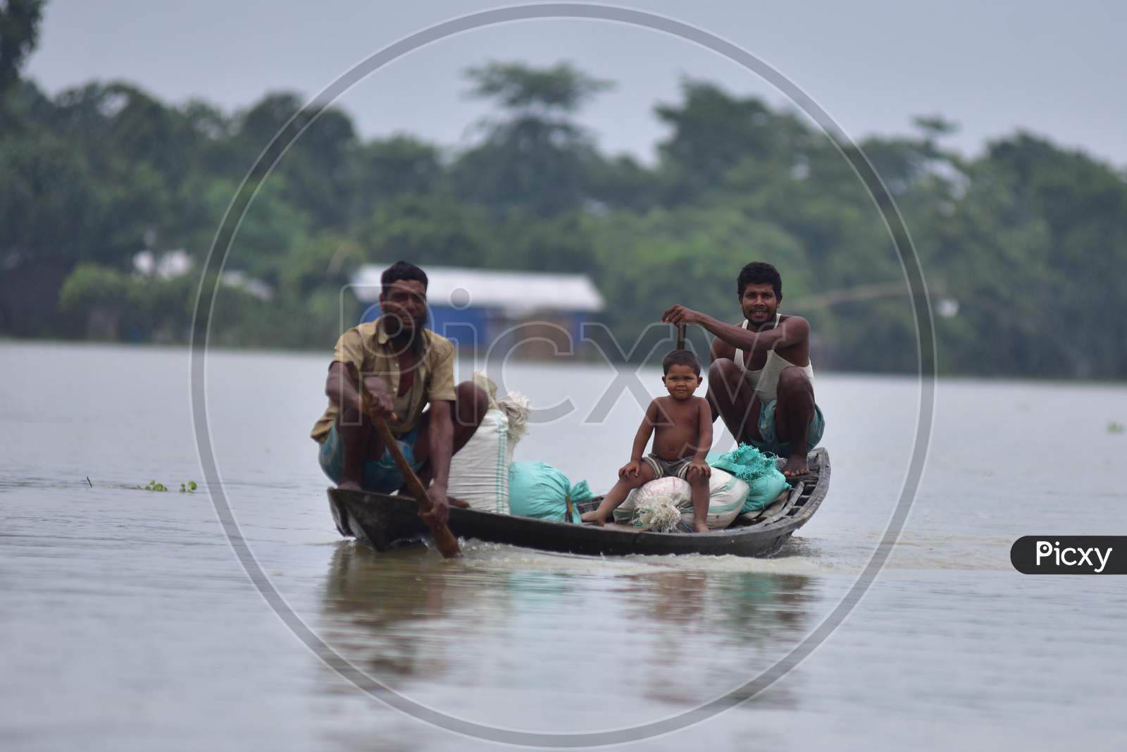 Flood Affected Villagers Are Transported On A Boat  Towards A Safer Place At  Sildubi Village In Morigaon District Of Assam On June 29, 2020