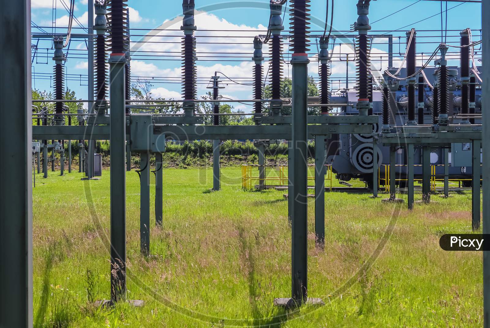 Electrical Transformer. Distribution Of Electric Energy At A Big Substation With Lots Power Lines On A Sunny Day