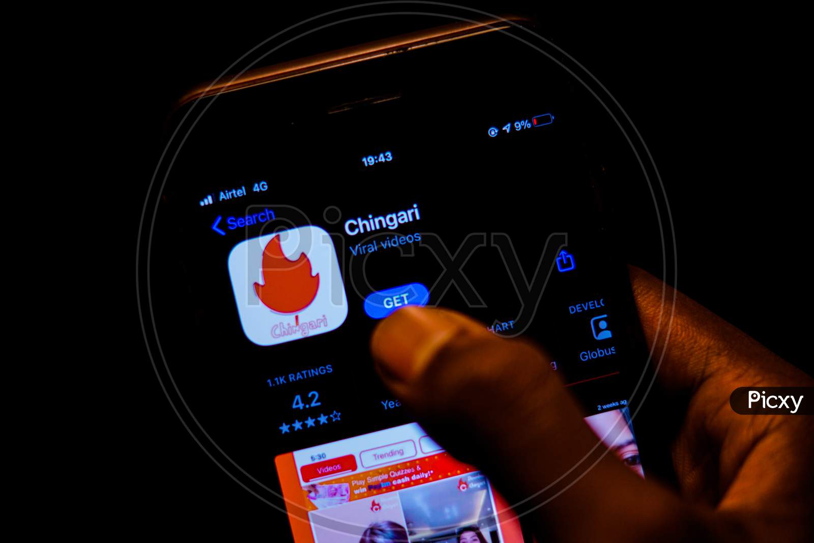 Chingari App on Mobile screen with a finger about to Download the App from the Appstore
